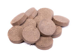 Dry peat pellets, compressed compost tablet
