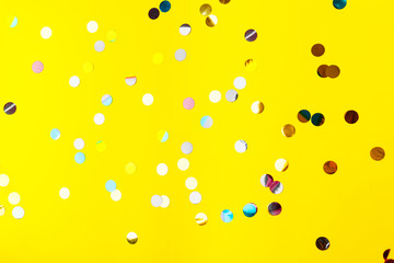 colorful sprinkles over yellow background, decoration for holiday and party