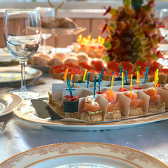 Fresh appetizers canapes with salmon on a table on the garden terrace