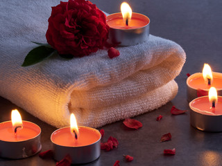 Spa composition of candles and rose.
