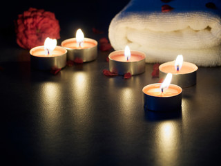 Spa composition of candles and rose.