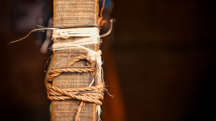 Wooden pole with rows of ropes tied