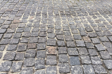 Gray Paving stone, background. Pedestrian zone in the park in daylight. Urban sett, walkway.