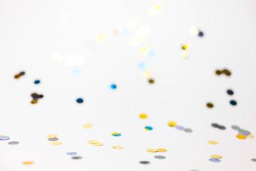 Colorful confetti on white background with copy space