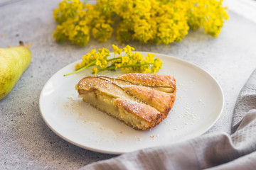 Delicious pear and almond pie. Romantic summer composition with flowers