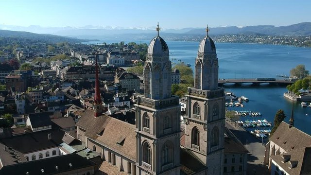 Zurich and Grossm&uuml;nster Church with the Swiss alps.