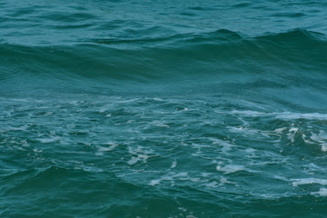 Naklejka na ściany i meble Blue sea That is a wave, because the strong wind causes the beautiful water to rise