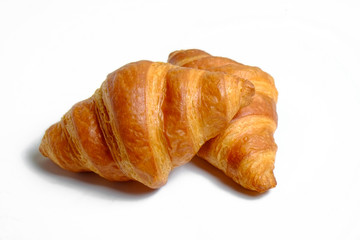 Studio shot of appealing plain mini croissant baked to golden crisp isolated on white backgroud. Traditional french pastry. Close up, copy space, top view.