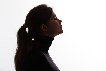 silhouette girl portrait with closed eyes on white isolated background, young woman profile in...