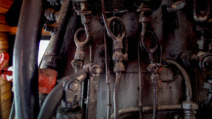 Closeup image of old rusty metal pipes and valves at old steam locomotive