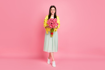 Full length photo of pretty cheerful lady hold big fresh tulips bunch thankful compliment wear...
