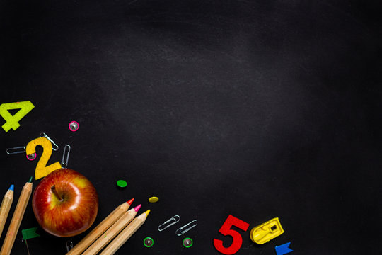 books on the table and pencils, ABC inscription, black board, apple , image concept, schooling, no one