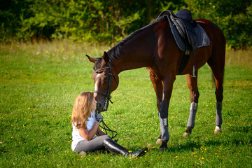 Beautiful young girl rider and her horse