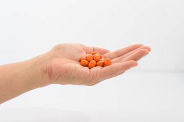 Pick up vitamin capsules to eat