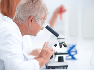 female scientist conducts research in the laboratory.