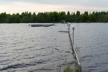 A pier submerged in high water, a pier for boats under water