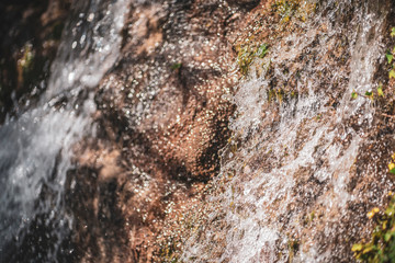 water falling through a stone waterfall