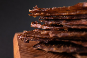 Close-up of a piece of meat on a wooden Board with spices. Restaurant menu, a series of photos of different dishes