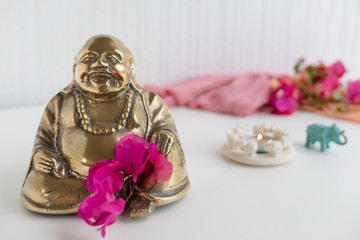 Happy Buddha and candle