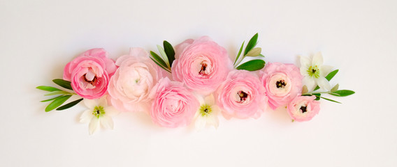 Studio shot of beautiful bouquet of pale pink ranunculus flowers with visible petal texture. Close up composition with bright patterns of flower buds. Top view, isolated, copy space.