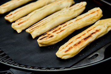 Grilled cheese puff pastry on the grill gas outdoor.