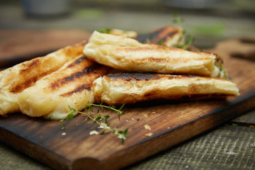 Grilled cheese puff pastry on the wooden cutting board.
