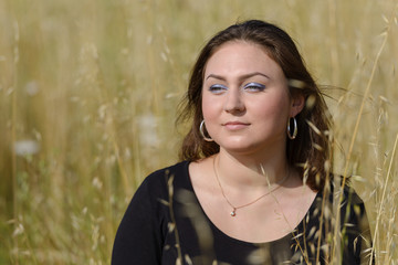 girl in a yellow field on a natural background