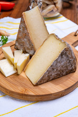 Cheese tomme de montagne or tomme de savoie made from cow milk in French Alps.