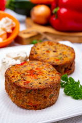 Tasty vegetarian food, burgers with Greek feta cheese, sweet red paprika, green olives and zucchini