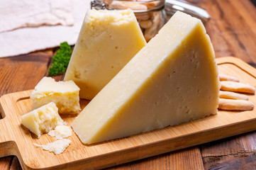 Pieces of matured pecorino romano italian cheese made from sheep milk in Lazio, Sardinia or Tuscany