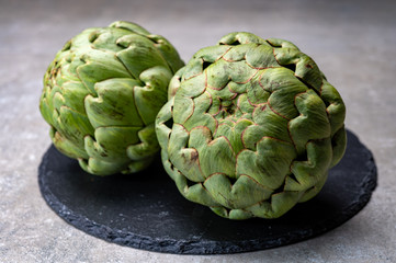 Big ripe uncooked green globe artichoks vegetables