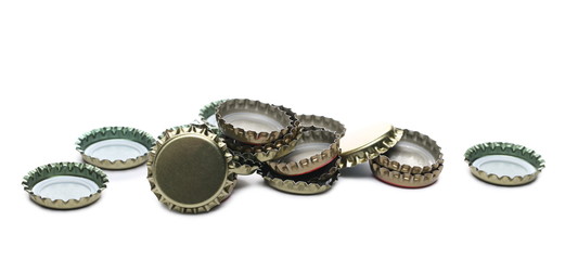 Bottle caps pile isolated on white background