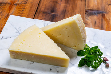 Pieces of matured pecorino romano italian cheese made from sheep milk in Lazio, Sardinia or Tuscany