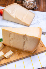 Big wedges of parmigiano-reggiano parmesan hard Italian cheese made from cow milk or Grana Padano