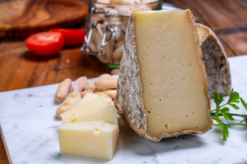 Cheese tomme de montagne or tomme de savoie made from cow milk in French Alps.