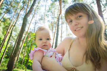 Young mother with her little baby. Loving mother takes care of her daughter