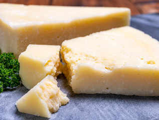 Pieces of matured pecorino romano italian cheese made from sheep milk in Lazio, Sardinia or Tuscany