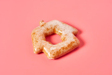 Festive christmas cookie in shape of house on pink background. New year celebration concept