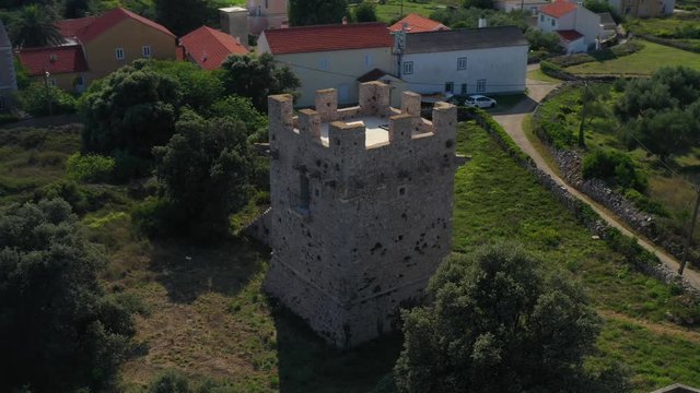 17th Century Defensive Tower On The Beautiful Island Of Olib In Croatia - aerial circling shot