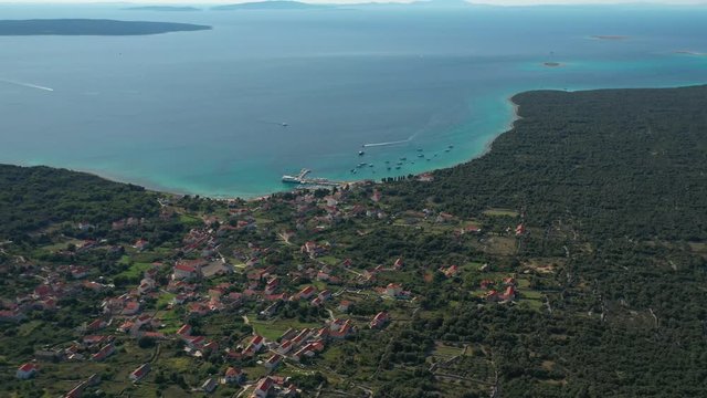 Flying over the beautiful town in Olib Island, Croatia by the sea - aerial