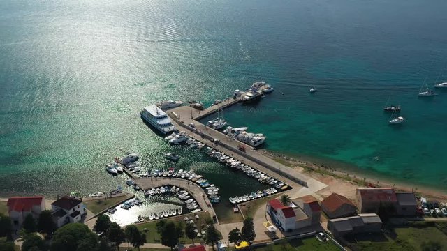 Sailboats, Fishing Boats, And Tourist Boats Docked On The Small Port Of Olib Island, Croatia On A Beautiful Sunny Day.- aerial drone shot