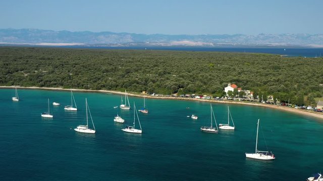 Olib Island In Croatia - Sailboats Adrift On The Turquoise Blue Sea Surrounding The Lush Paradise Island - aerial shot