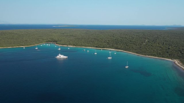 People on boats enjoying the clear, blue waters of the Olib Island in Croatia - aerial