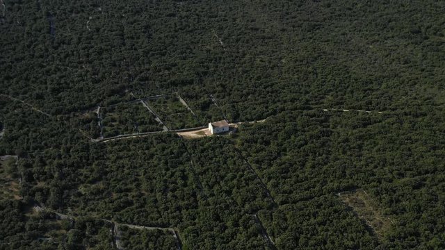 Bird's Eye View Of St. Roch Church Surrounded By Green Trees In Olib Island, Croatia - aerial shot