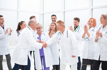 Fototapeta na wymiar happy medical colleagues shaking hands with each other.