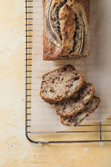 Homemade banana bread on a yellow background. 