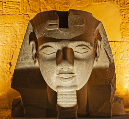 Fototapeta na wymiar Statue of pharaoh head at an ancient egyptian temple in night