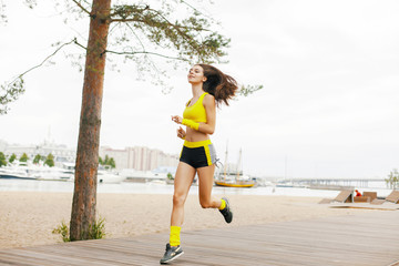 Young happy woman jogging