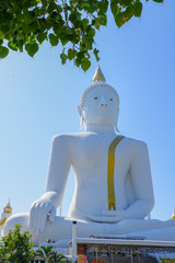 Big concrete Buddha statue with blue sky in WatPairogwour in Suphanburi province, Thailand