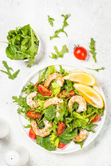 Shrimp salad with vegetables and leaves.
